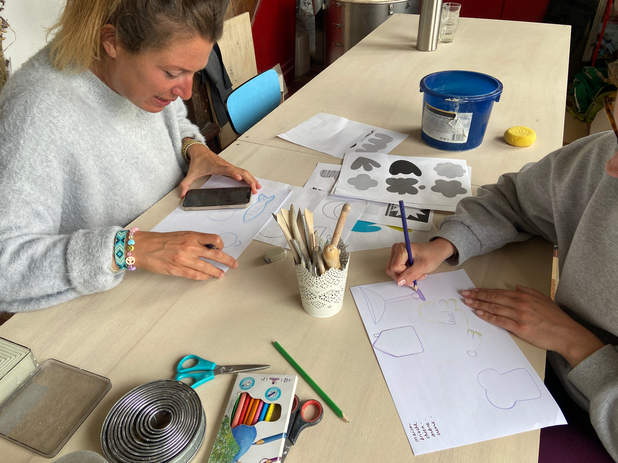 Travail préparatoire d'un cours de poterie par Florine est Micheline. Les élèves réalisent des croquis de leurs futurs pièces en céramique